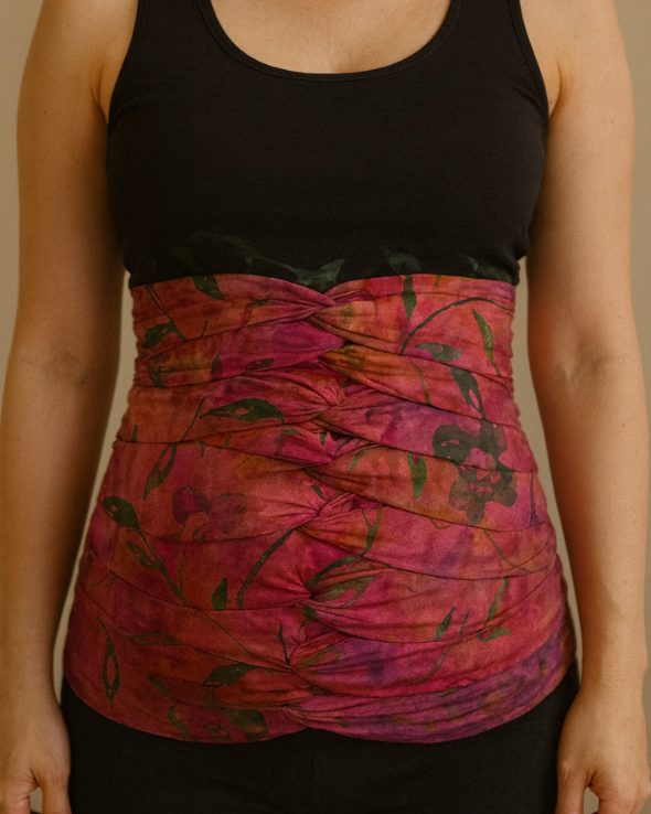 Rainbow floral bengkung belly wrap with vibrant postpartum design.
