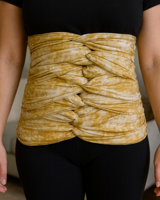 White and gold bengkung belly wrap for postpartum support.